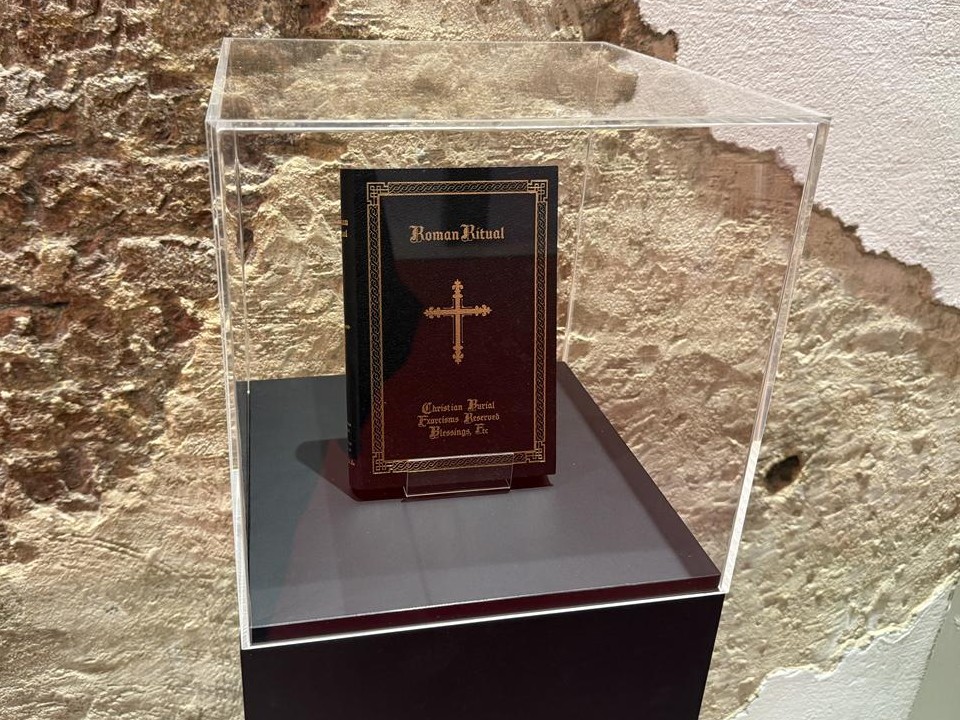 Book titled ‘Roman Ritual’ displayed inside a clear case