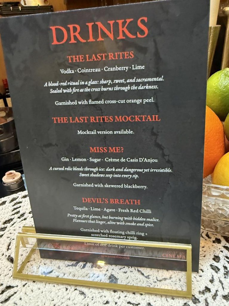 Drinks menu titled ‘Drinks – The Last Rites’ displayed on a stand.