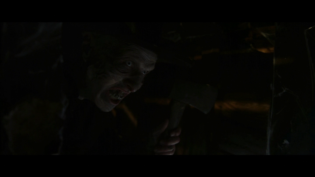 Menacing figure holding an axe in a crawlspace